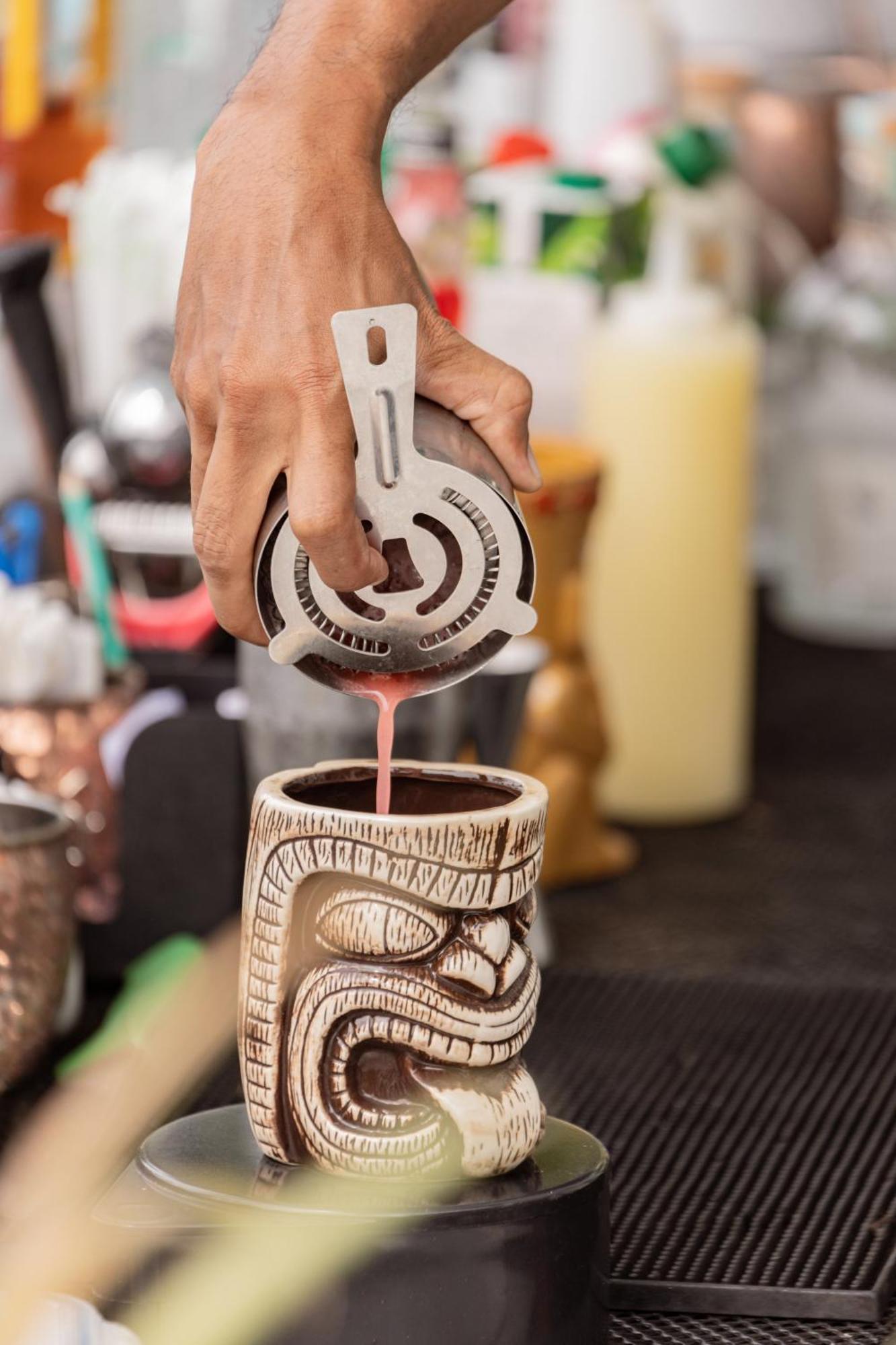 Skyview Resort Phuket Patong Beach Eksteriør billede A bartender straining a tiki drink